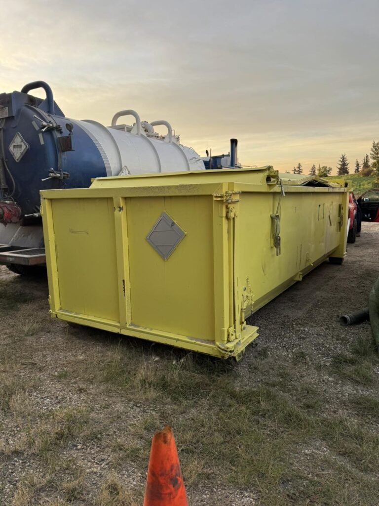 A yellow roll-off bin sits uncovered before shrink wrap.
