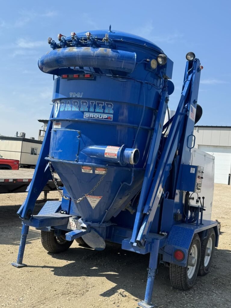 Trailer-mounted equipment sits uncovered before shrink wrap.